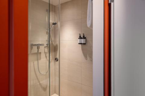Red shower stall with various shower products