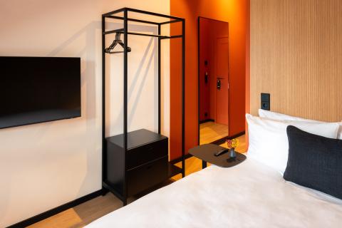Hotel room with simple design in red and black
