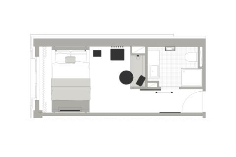 Umrissplan eines Hotelzimmers mit Bett und Badezimmer